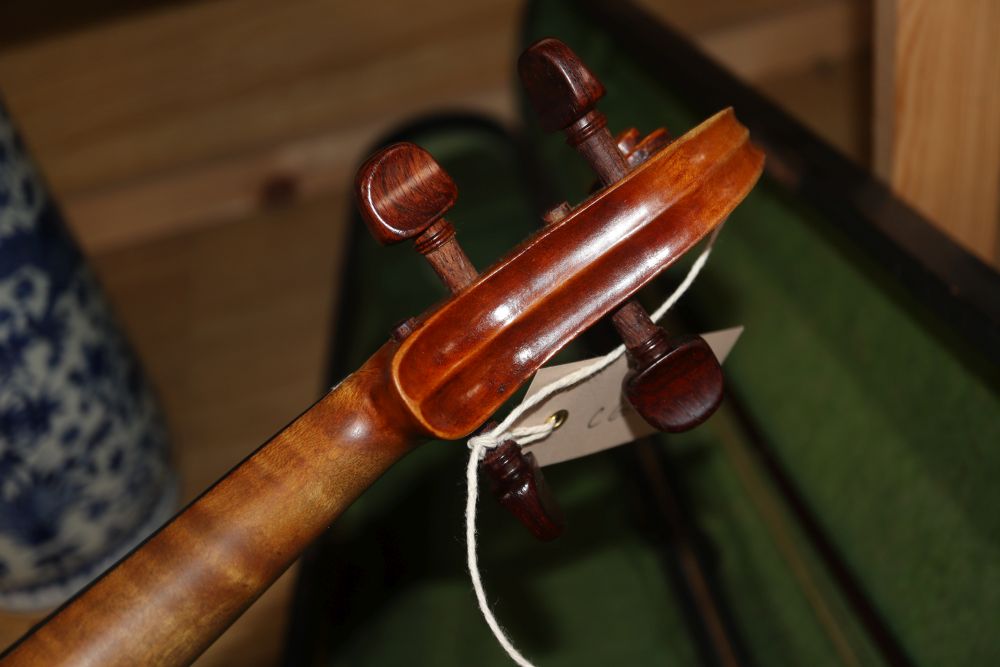 A late 19th century European violin with inlaid decoration, cased with bow, Joseph Guanaris label to interior of violin